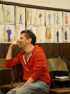 Directo David Cromer looks at costume sketches